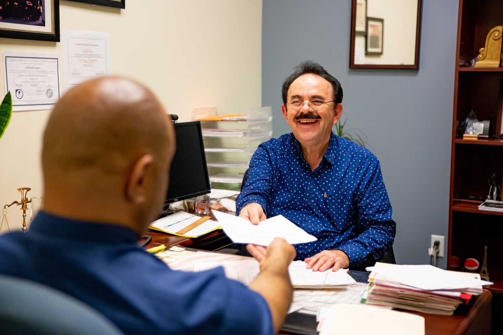 MAAC DUI Program Two men sitting at a table with papers in front of them.