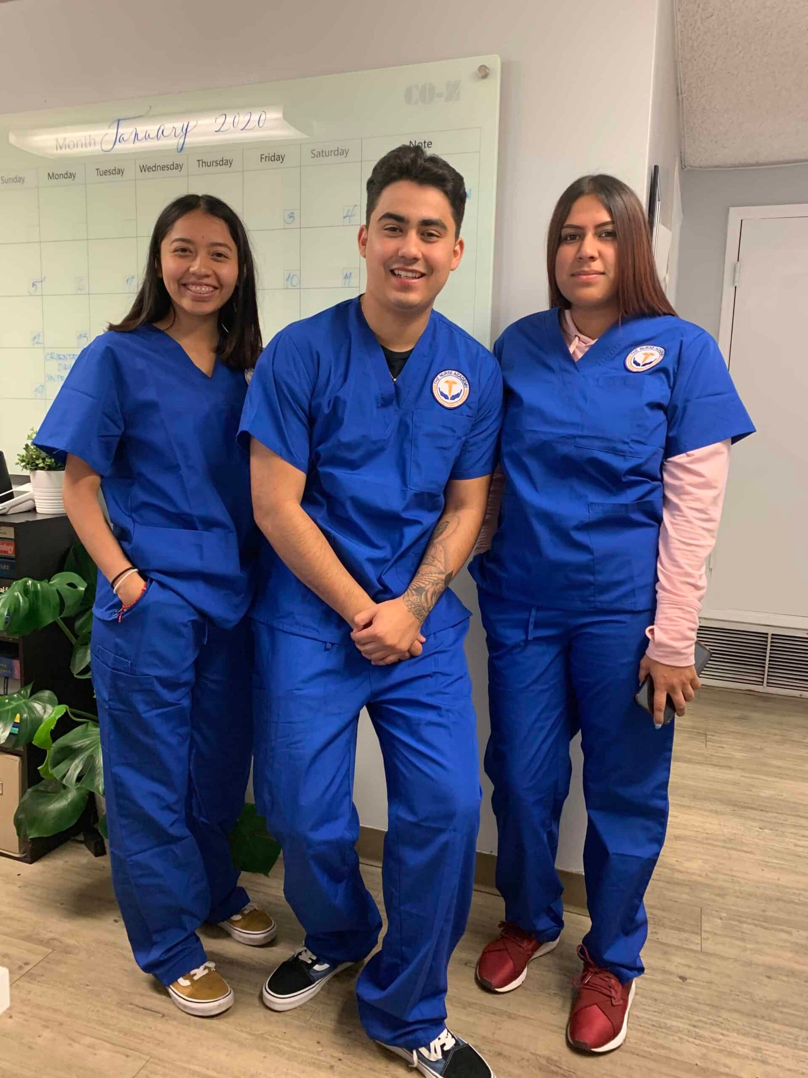 Career Pathways Three people in blue scrubs standing next to each other.