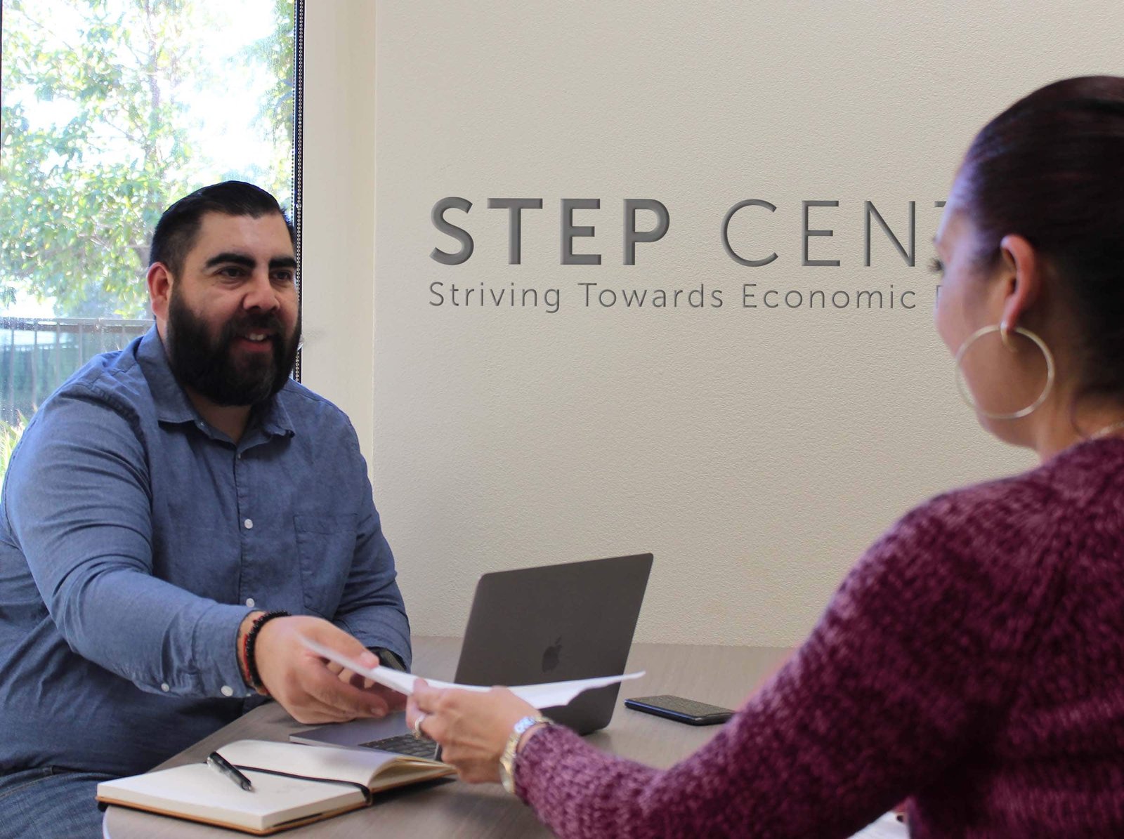 A man and woman are sitting at a table.