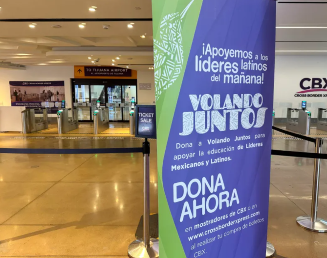 A sign in spanish is shown at an airport.