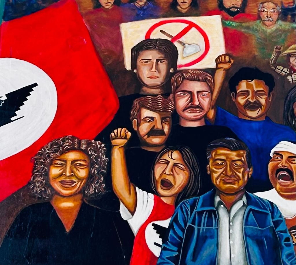 A painting of people protesting with one holding up a flag.