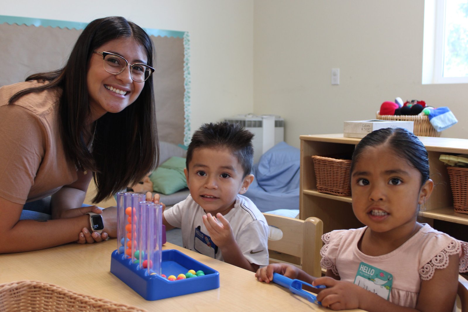 A woman and two children sitting at a table.