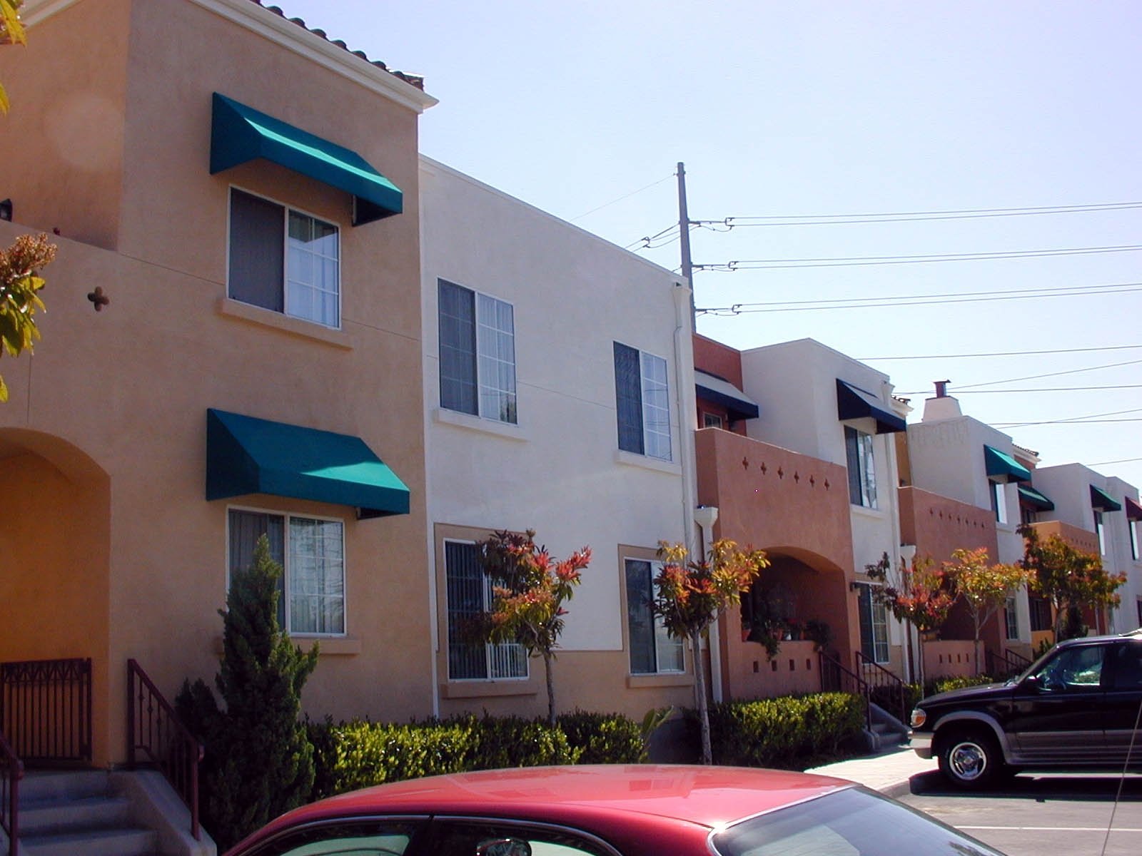 A red car parked in front of a building.