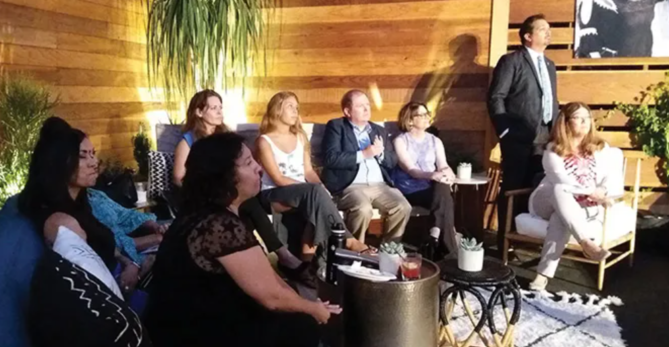 A group of people sitting around a room.