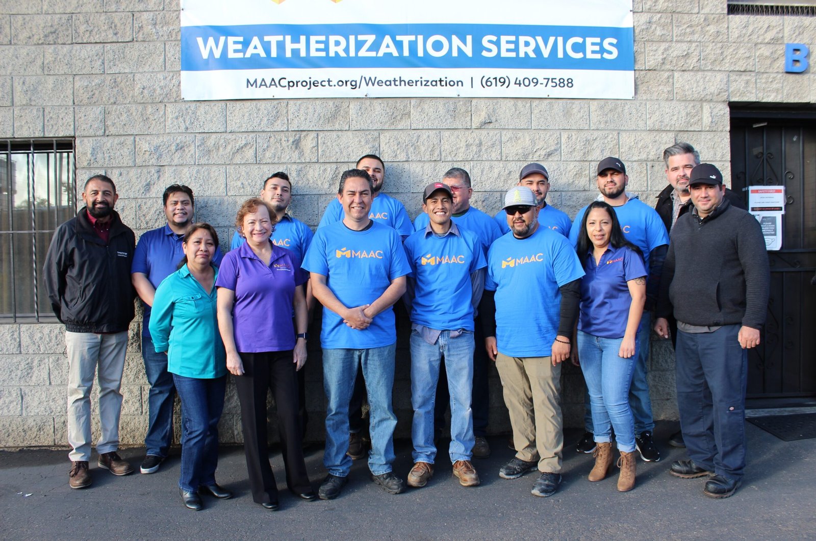 Weatherization 2023 A group of people standing in front of a building.