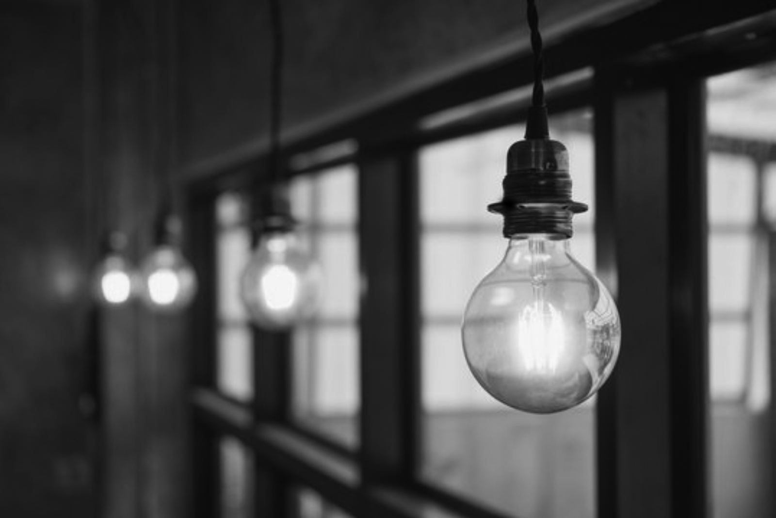 lights in window_bw A group of light bulbs hanging from the ceiling.