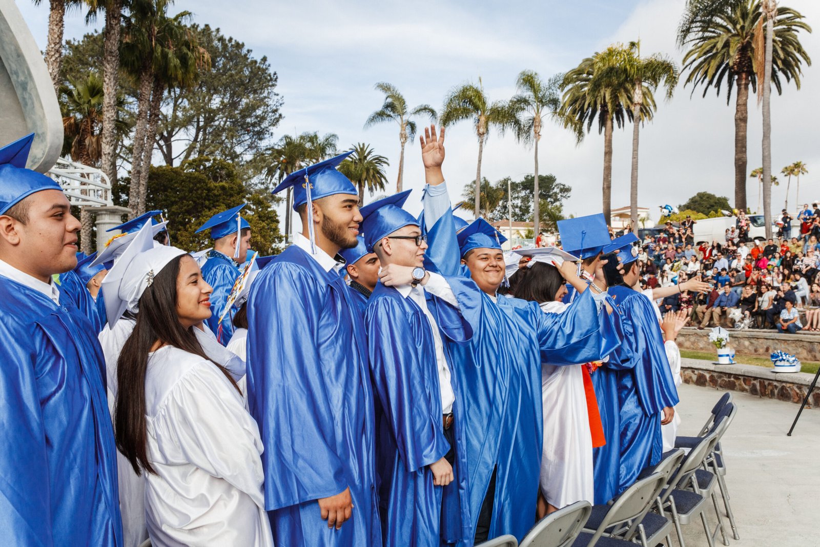 A group of people in blue caps and gowns