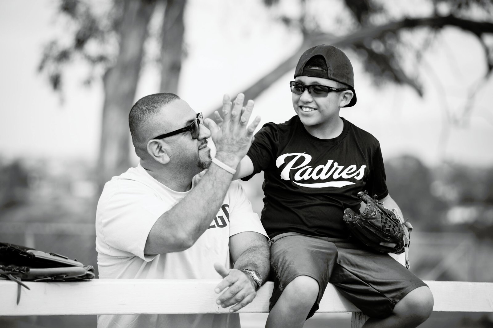 A man and boy sitting on top of a bench.