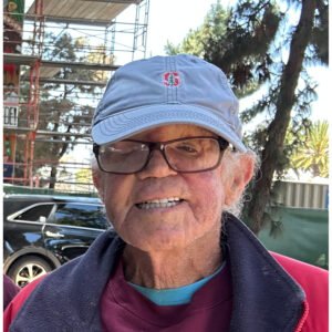A man wearing glasses and a hat.